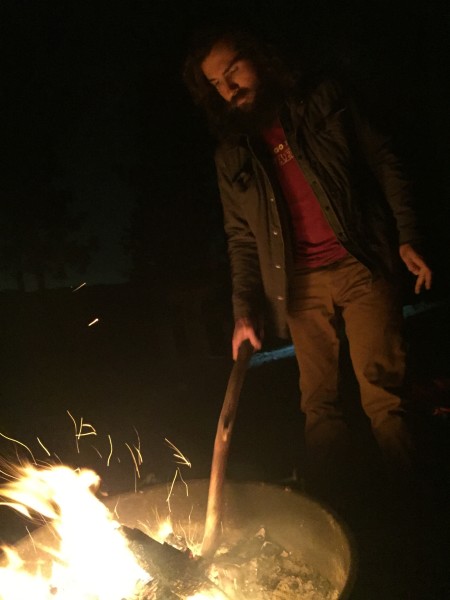 Jay stoking the campfire.